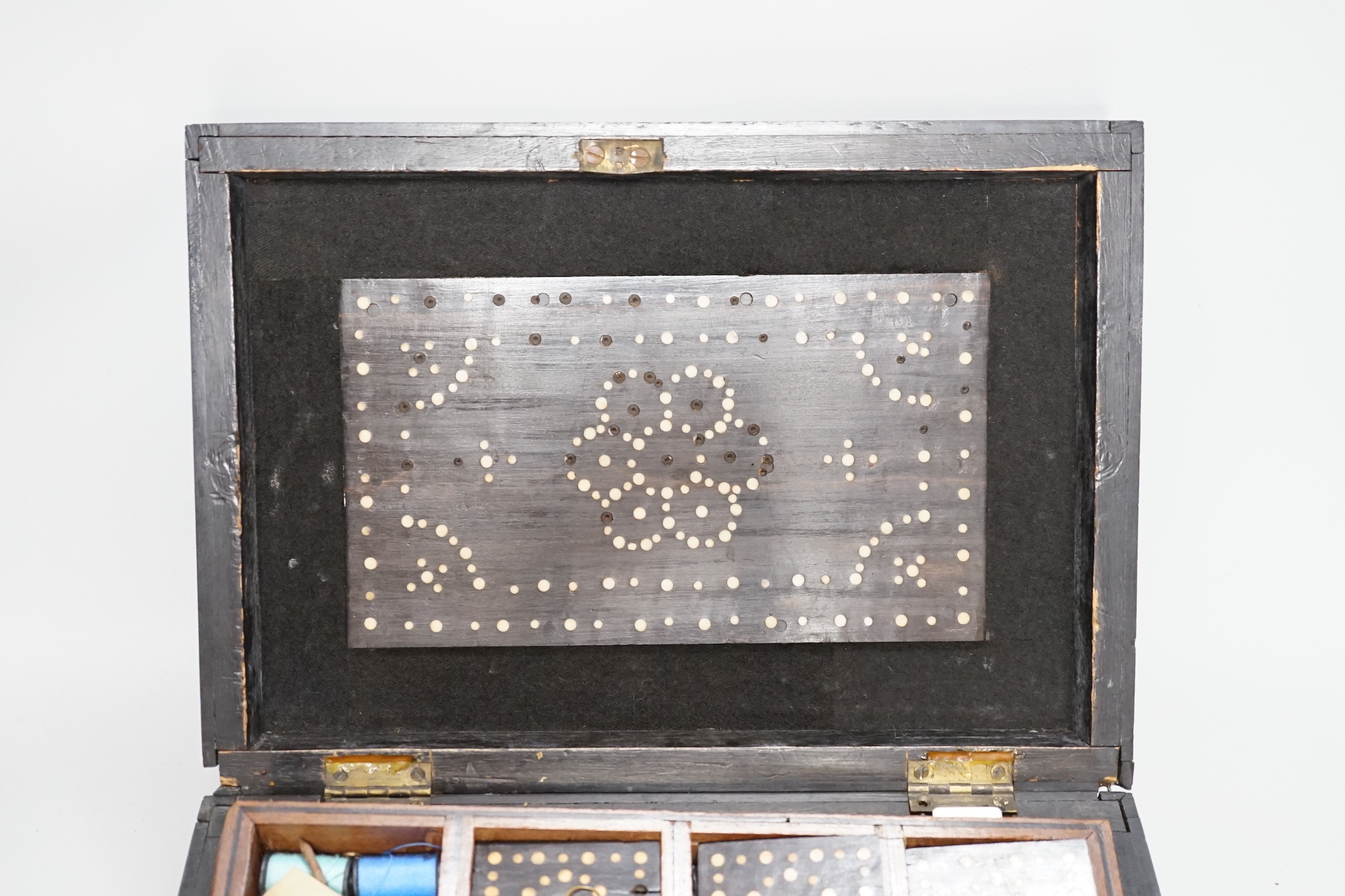 A 19th Century Ceylonese ebony, porcupine quill and bone inlaid sewing box with contents including cotton reels, 28cm wide